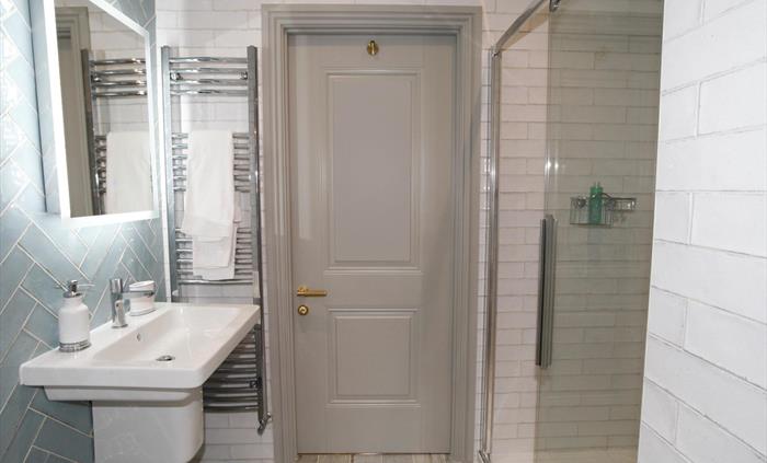 situated on the second floor between the master bedroom and the second bedroom. shower, wc, heated towel rail, bluetooth mirror and basin